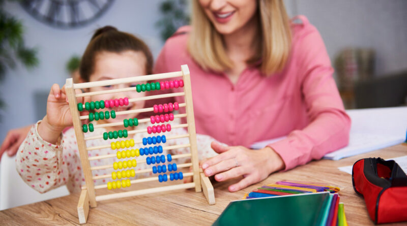 Mother and daughter having abacus kit